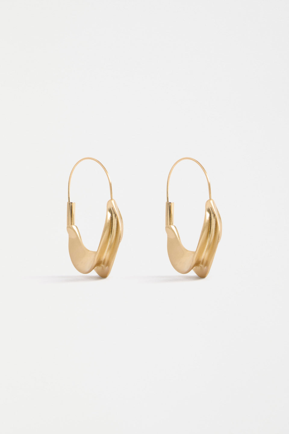 The Siita Hoop Earring features a sculptural petal-shaped base and fine closure for a modern take on the classic hoop | GOLD