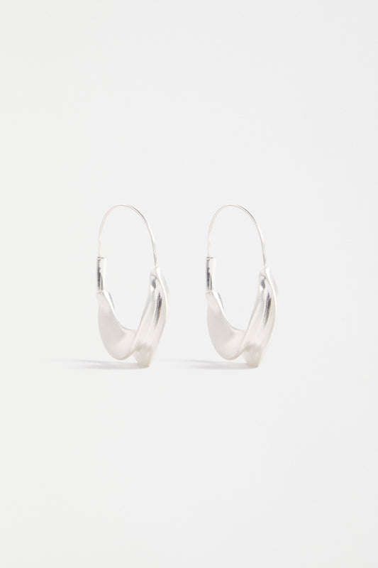 The Siita Hoop Earring features a sculptural petal-shaped base and fine closure for a modern take on the classic hoop | SILVER