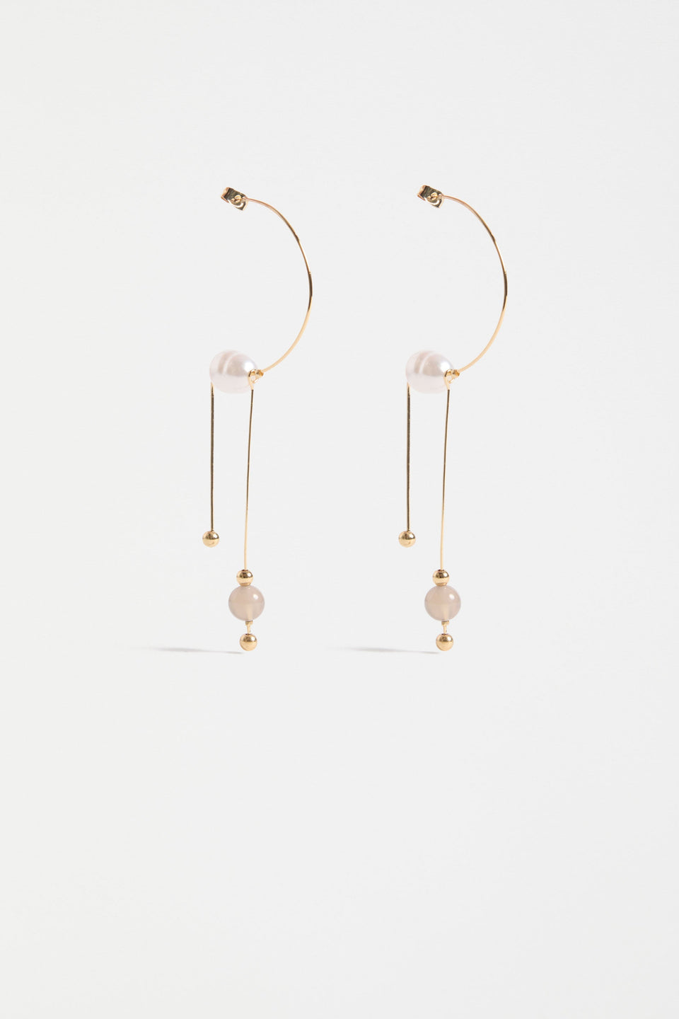 The Pykka Drop Earring features an open-end hoop with twin dangling stems, offering lightweight movement and a playful sculptural look | GOLD