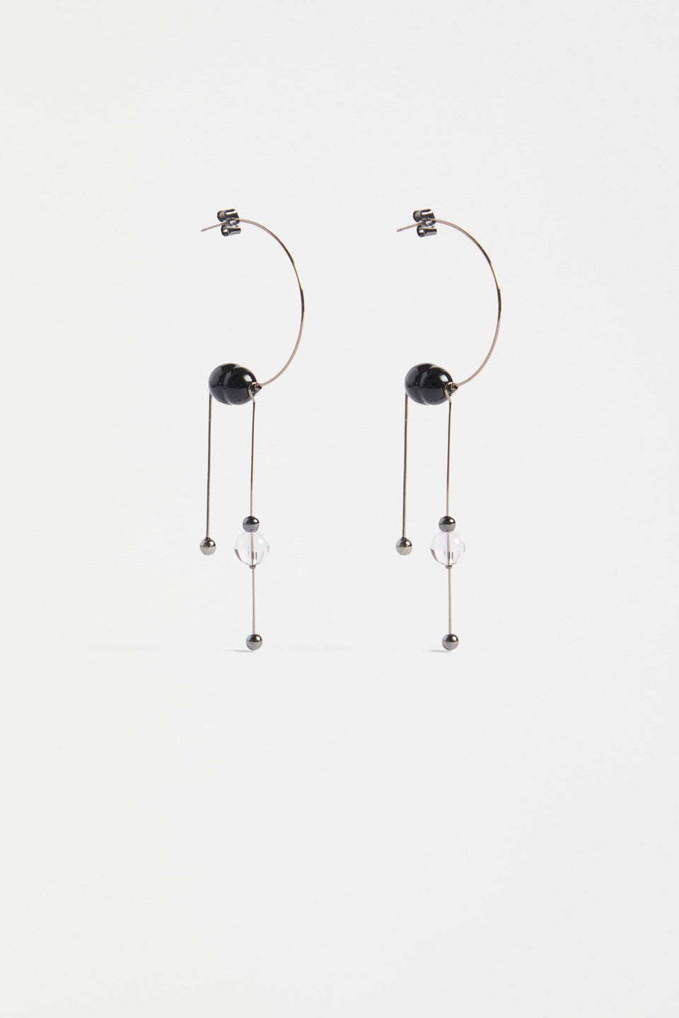 The Pykka Drop Earring features an open-end hoop with twin dangling stems, offering lightweight movement and a playful sculptural look | GUNMETAL