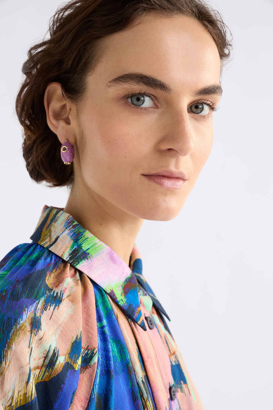 The Jans Hoop Earring features a chunky mini hoop silhouette with glossy enamel and metallic rivet detailing for a bold, playful finish, shown on model | LILAC