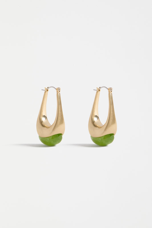 The Korvvo Long Hoop Earring features an elongated sculptural hoop with a coloured flecked glass bead, adding bold elegance to evening looks | CELERY