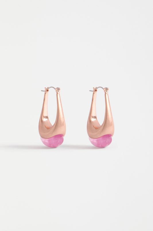 The Korvvo Long Hoop Earring features an elongated sculptural hoop with a coloured flecked glass bead, adding bold elegance to evening looks | LILAC