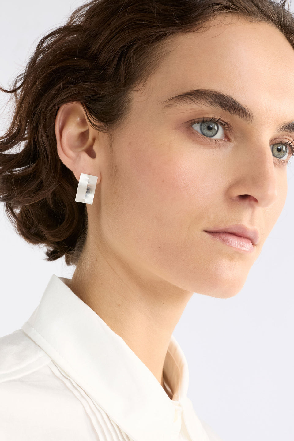 The Trel Stud Earring features a sleek rectangular shape with a folded cut-out detail model | GOLD