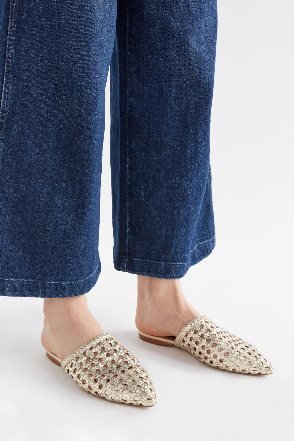 Lyd Woven Metallic Flat Pointed Toe Mule Model Angled Front | GOLD