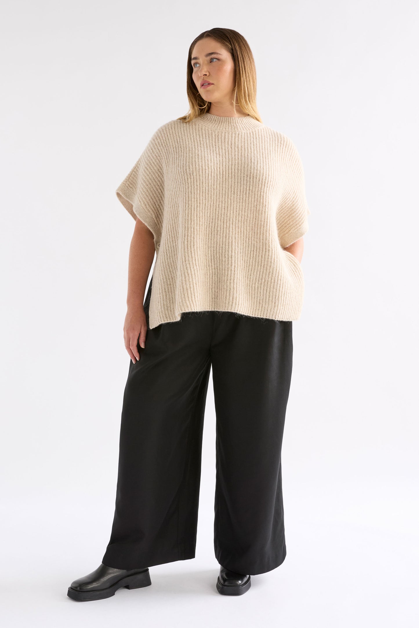 Kaanto Boxy Funnel Neck Rib Stitch Alpaca-Merino Wool Knit Poncho Model Chanel Front Full body | LATTE