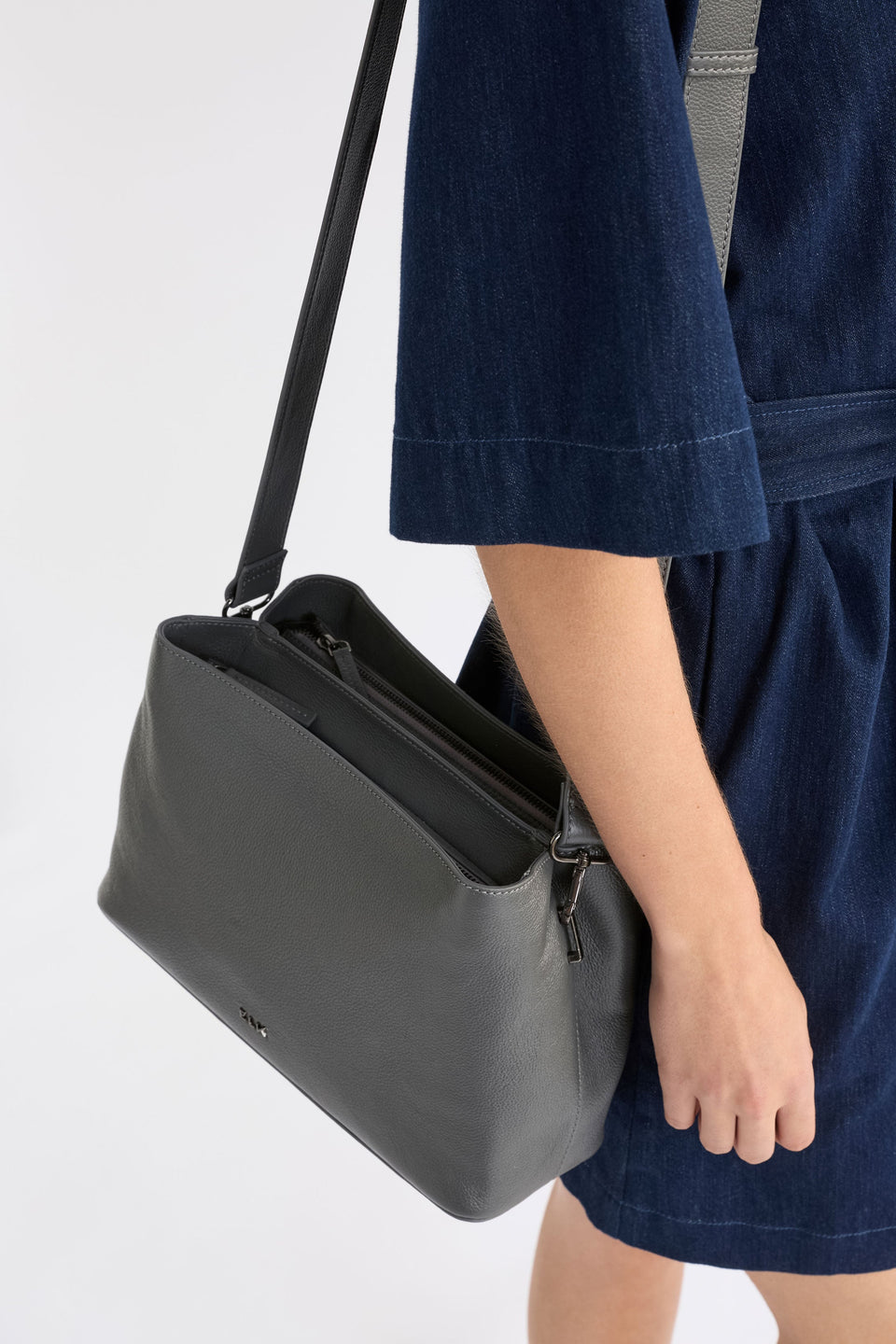 Niv Bag on model with strap and zips  | DARK GREY