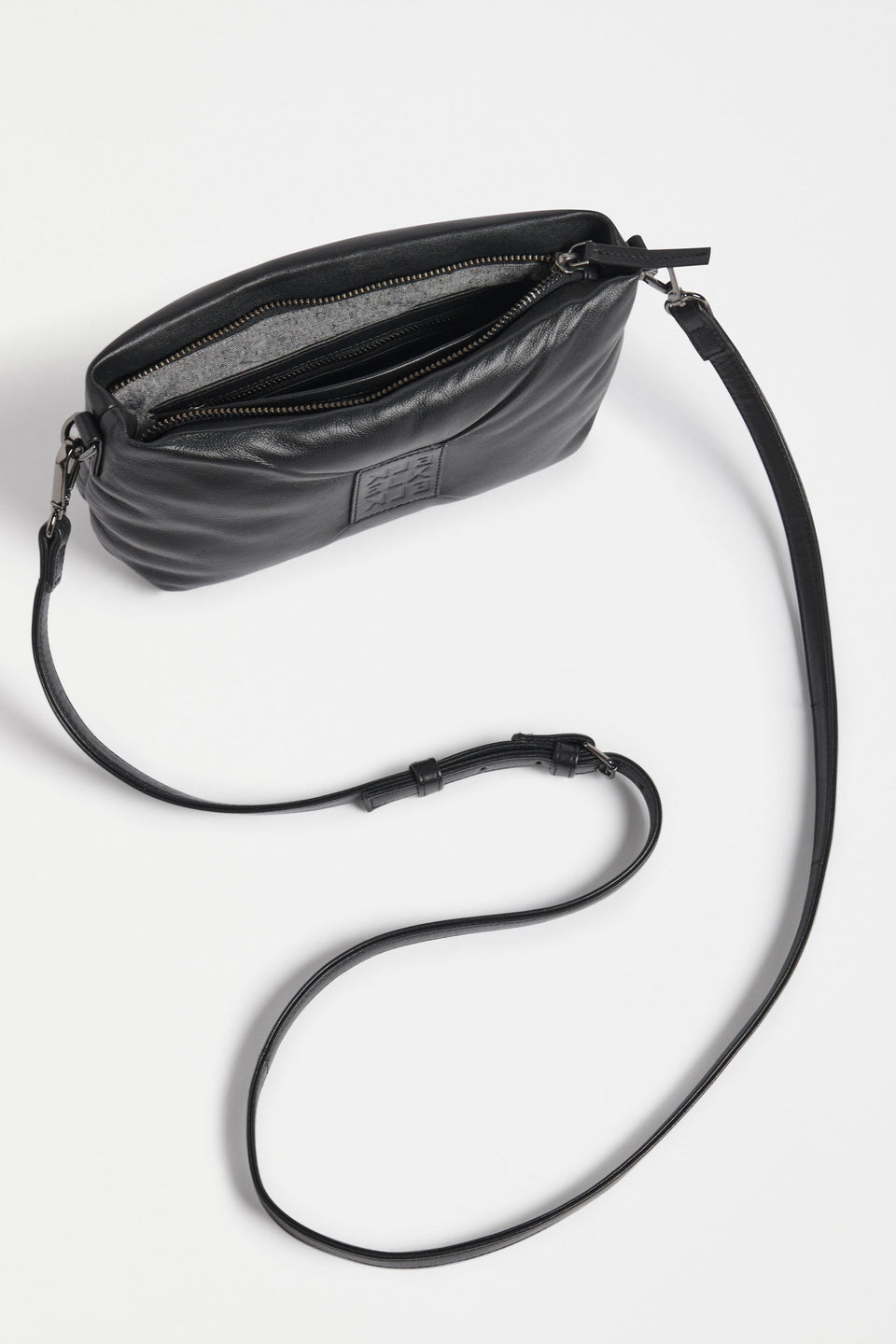 Moln Clutch Bag Flat Lay with strap extended and inside pocket detail | BLACK