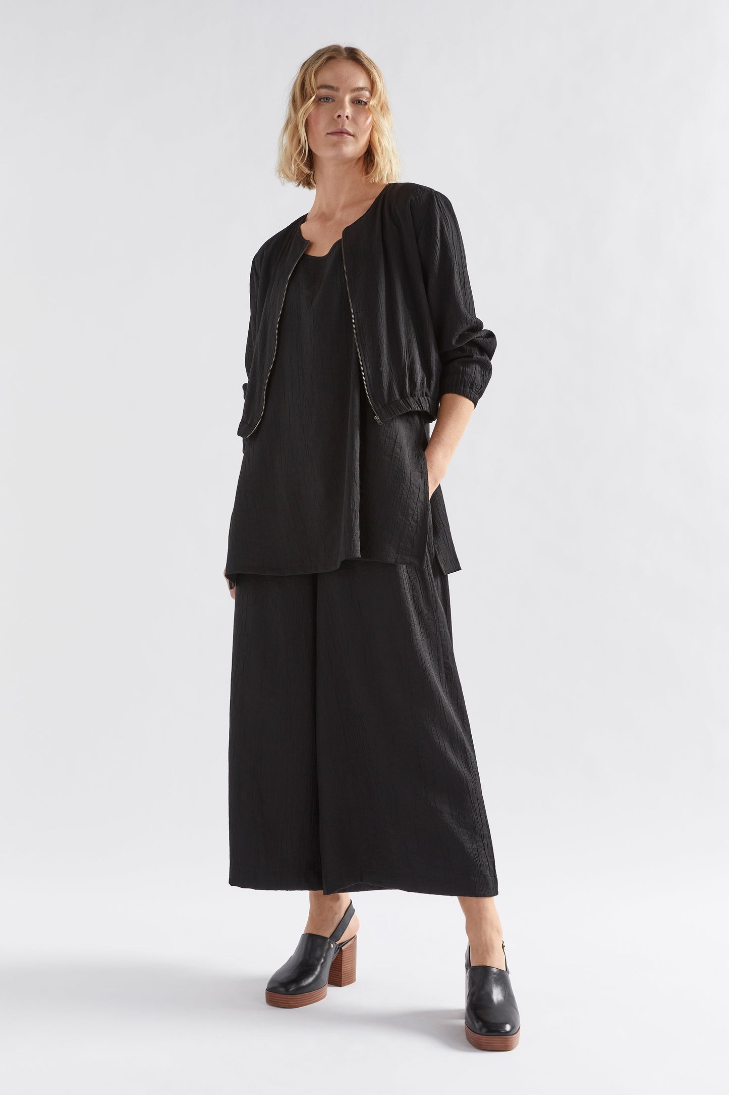 Joen Crinkle Fabric Tunic Top Model Angled Front with Jacket | BLACK