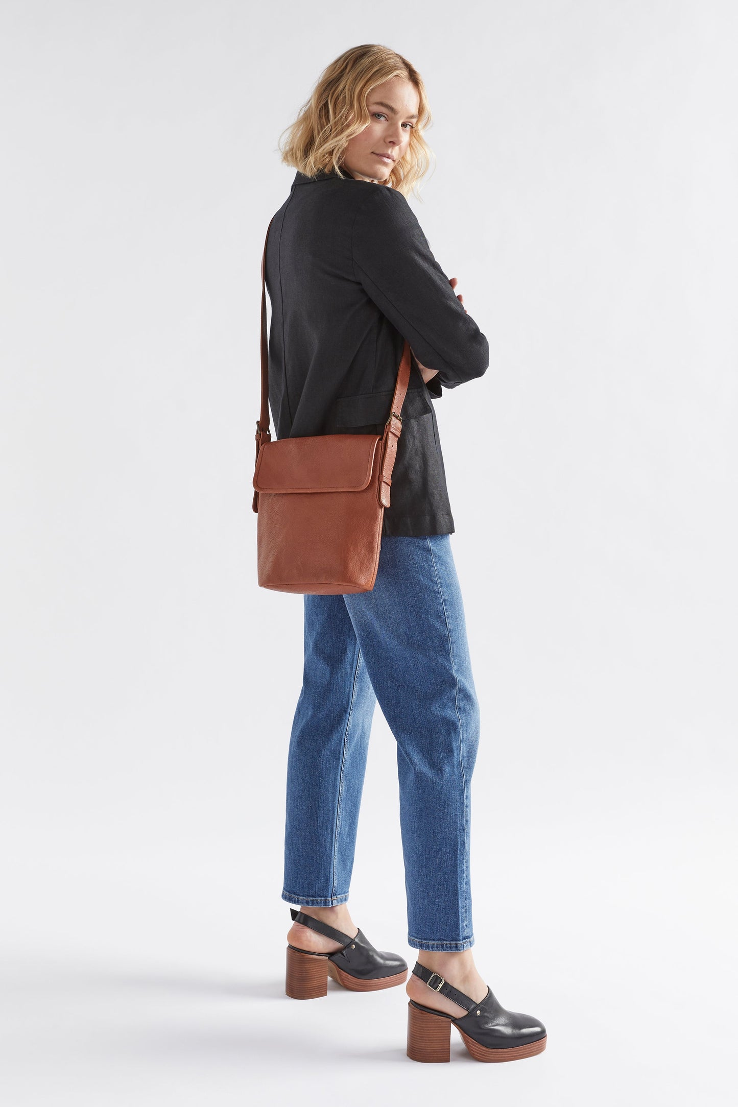 Teo Medium sized Leather Crossbody Bag with flap front full body TAN